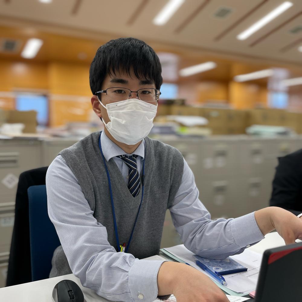 デスクで仕事をしている箱崎翔哉さんの写真