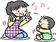 赤ちゃんとエプロンを付けた女性が向かい合って手遊びをしている様子